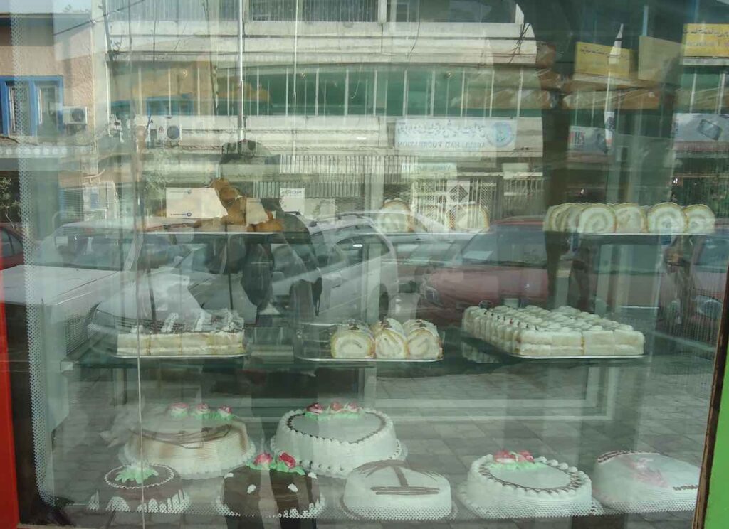 Kabul bakery window displaying various cakes