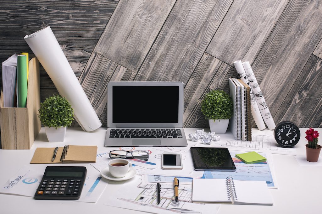 Desk with laptop: Manufactured Spending with a Full Time Job