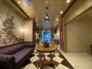 Hotel lobby with a purple couch and ornate decor