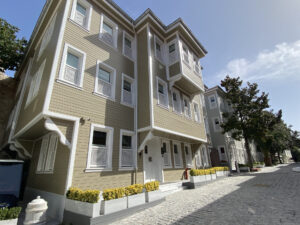 Yellow Ottoman style townhouse building on a narrow Istanbul street