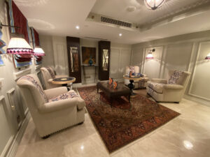 Living room with a red Turkish rug and plush white chaise seats