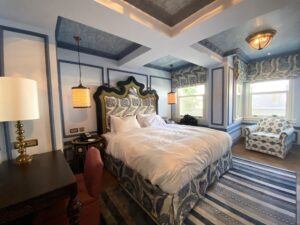 Hotel room with plush king sized bed and ornate paneling