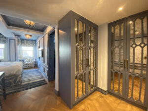 Two blue mirrored closets facing each other