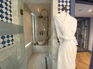 White robe hanging outside a hammam and shower