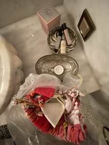 Metal hammam kit with a red loofah and olive soap