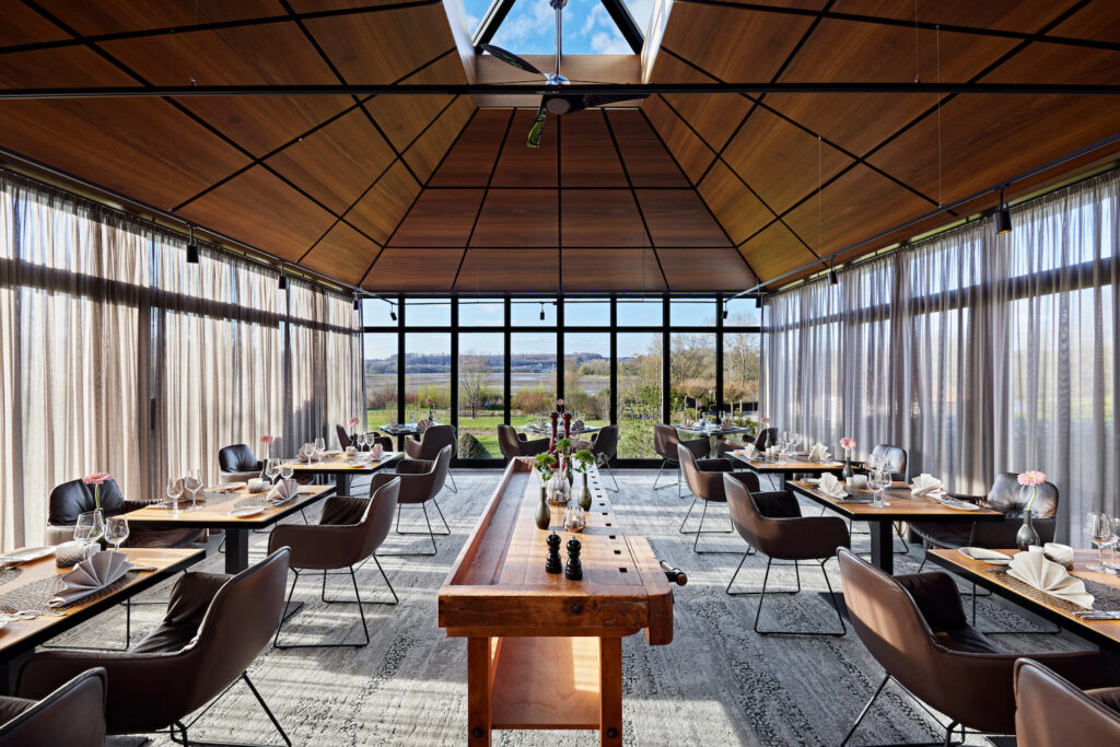 Hotel restaurant with glass panels overlooking grassland